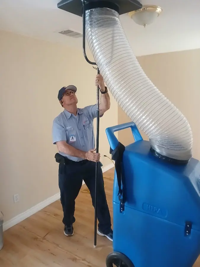 Furnace Tune-Up technician using HEPA equipment in Shelton