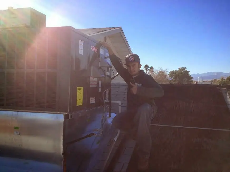HVAC technician performing HVAC Inspection on a rooftop unit in Shelton